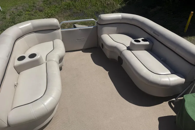 Slide: The Image of Interior seating of a 2003 Godfrey 2200 RE pontoon boat with cup holders. - 10