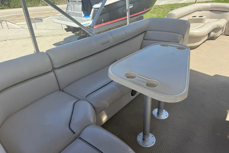 Slide: The Image of Luxurious seating area on a 2003 Godfrey 2200 RE boat with cupholders. - 12