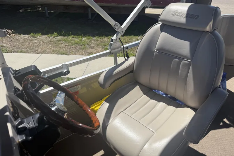 Slide: The Image of Captain's chair and steering wheel of a 2003 Godfrey 2200 RE boat. - 24