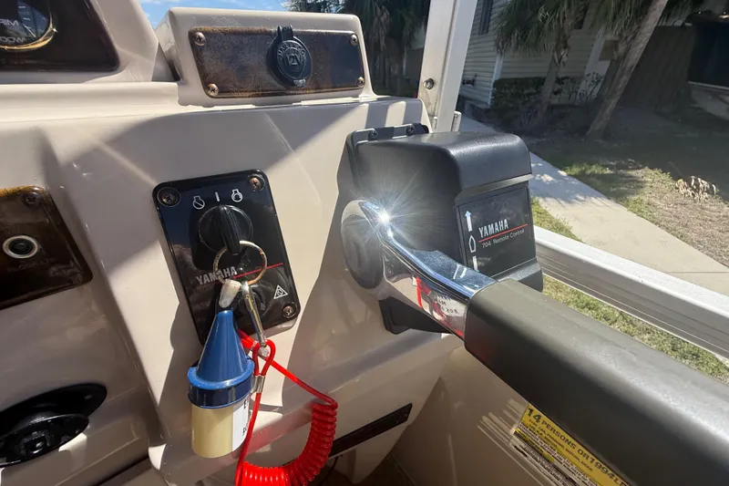 Slide: The Image of Control panel of a 2003 Godfrey 2200 RE boat with Yamaha remote control. - 25