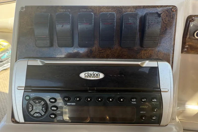 Slide: The Image of Control panel of a 2003 Godfrey 2200 RE boat with Clarion audio system. - 26