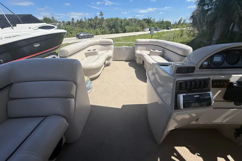 Slide: The Image of Interior of a 2003 Godfrey 2200 RE boat with plush seating and control panel. - 30