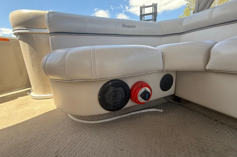 Slide: The Image of 2003 Godfrey 2200 RE boat interior with beige seating and audio controls. - 31