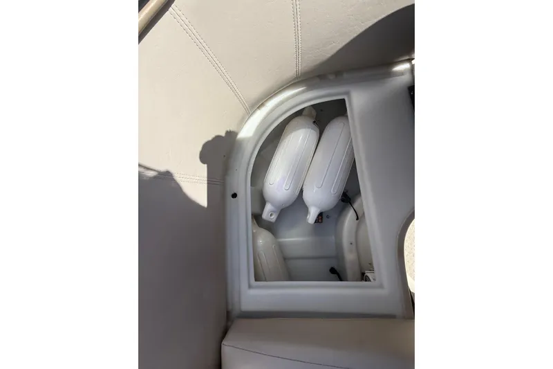 Slide: The Image of Storage compartment with white fenders on a 2003 Godfrey 2200 RE boat. - 32