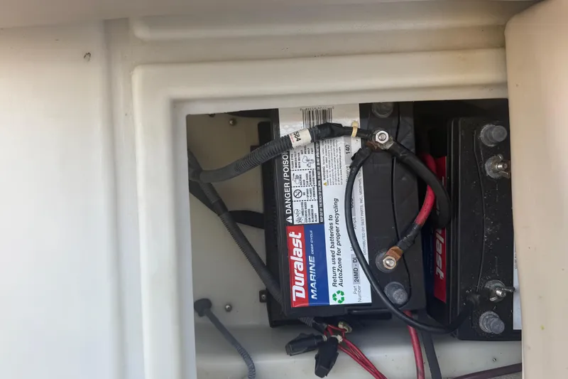 Slide: The Image of Marine battery compartment in a 2003 Godfrey 2200 RE boat, featuring Duralast battery. - 36