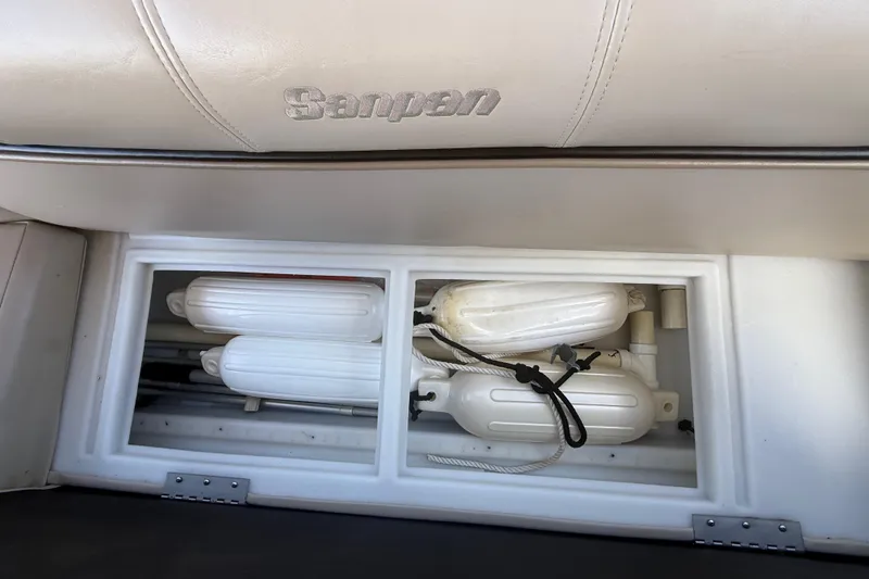 Slide: The Image of Storage compartment in a 2003 Godfrey 2200 RE boat with white fenders. - 37