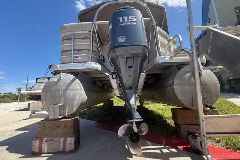 Slide: The Image of 2003 Godfrey 2200 RE pontoon boat with 115 horsepower outboard motor on blocks. - 40