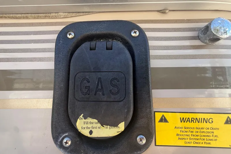 Slide: The Image of Gas cap on 2003 Godfrey 2200 RE with warning label for fuel safety. - 43