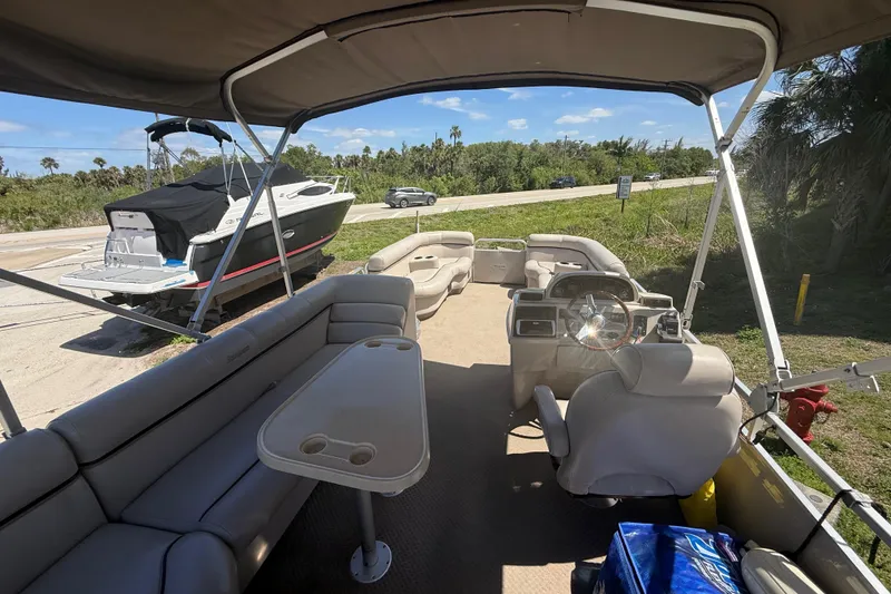 Slide: The Image of Interior of a 2003 Godfrey 2200 RE pontoon boat with seating and steering wheel. - 7