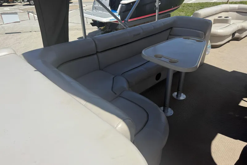 Slide: The Image of Luxurious seating area on a 2003 Godfrey 2200 RE boat with table and cup holders. - 9