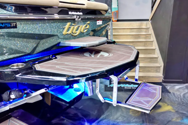 Slide: The Image of 2026 Tigé Z3 boat on trailer with illuminated blue lights in showroom. - 13