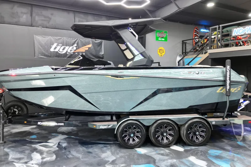 Slide: The Image of 2026 Tigé Z3 boat on trailer in showroom, sleek design, modern features. - 3