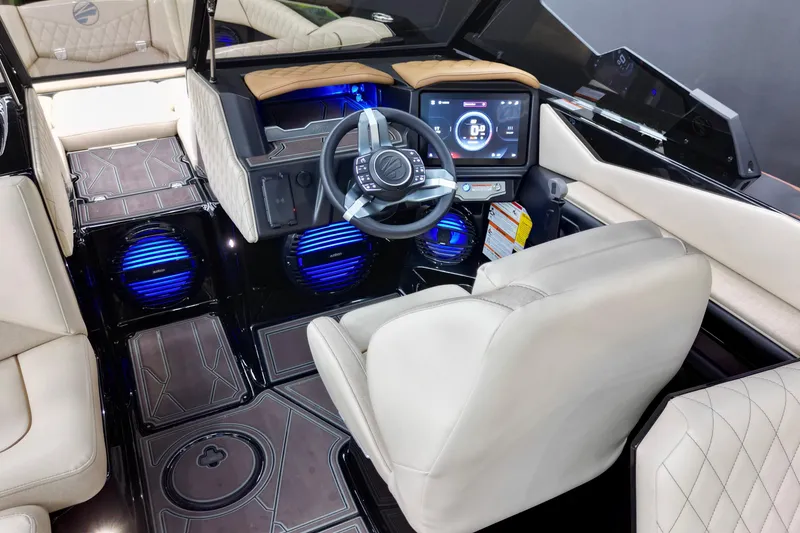 Slide: The Image of 2026 Tigé Z3 boat interior with modern dashboard, steering wheel, and illuminated speakers. - 8