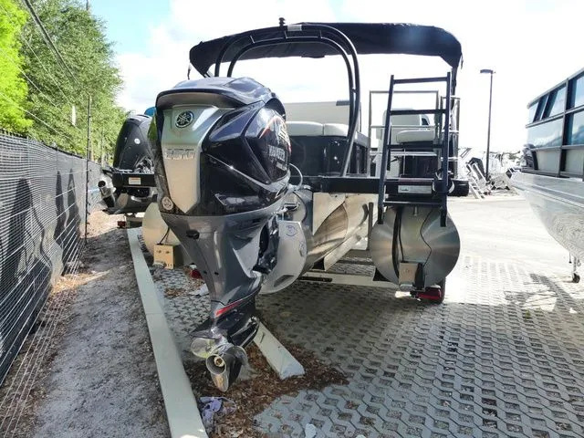 Slide: The Image of Godfrey Pontoons Sweetwater 2486 SFL 2026 with outboard motor on parking lot. - 3