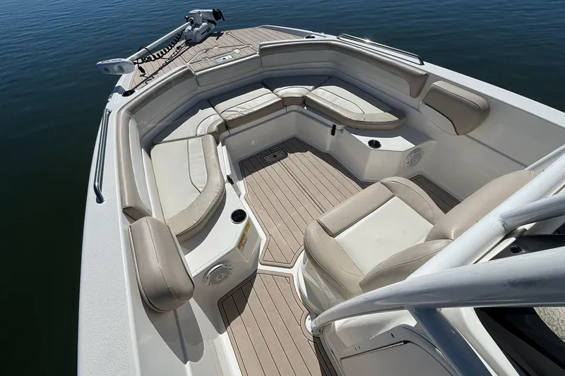 Slide: The Image of 2016 NauticStar 231 Coastal boat interior with cushioned seating and wood-style flooring. - 11