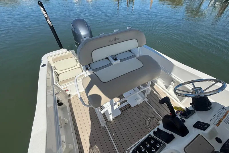 Slide: The Image of 2016 NauticStar 231 Coastal boat interior with steering wheel and seating. - 12