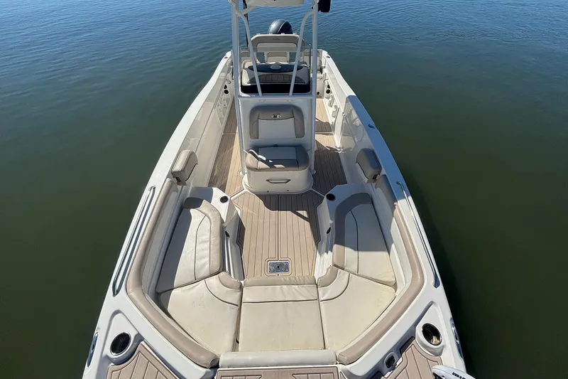 Slide: The Image of 2016 NauticStar 231 Coastal boat interior with seating, on calm water. - 13