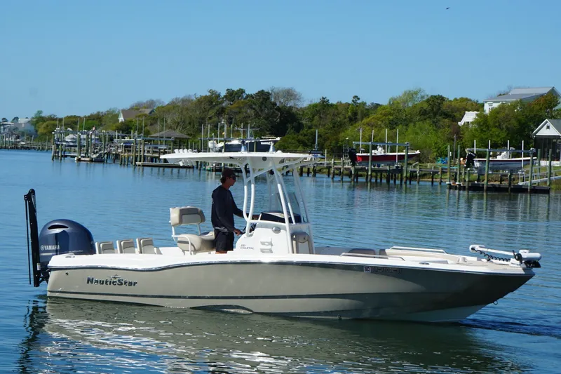 Slide: The Image of 2016 NauticStar 231 Coastal boat cruising on a calm waterway. - 14