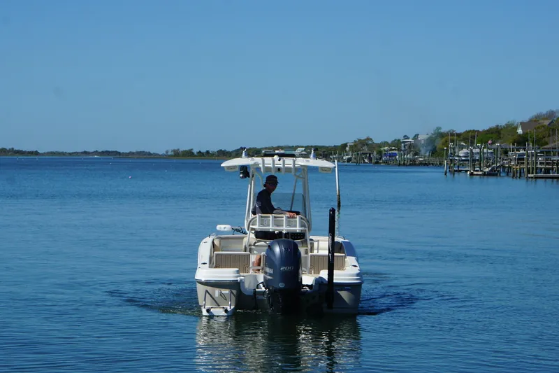 Slide: The Image of 2016 NauticStar 231 Coastal boat cruising on a calm blue waterway. - 17