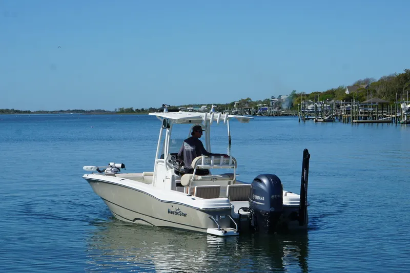 Slide: The Image of 2016 NauticStar 231 Coastal boat cruising on a calm, scenic waterway. - 4