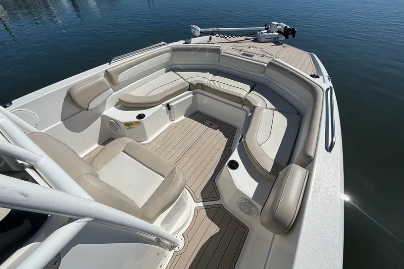 Slide: The Image of 2016 NauticStar 231 Coastal boat interior with beige seating and wood-style flooring. - 5
