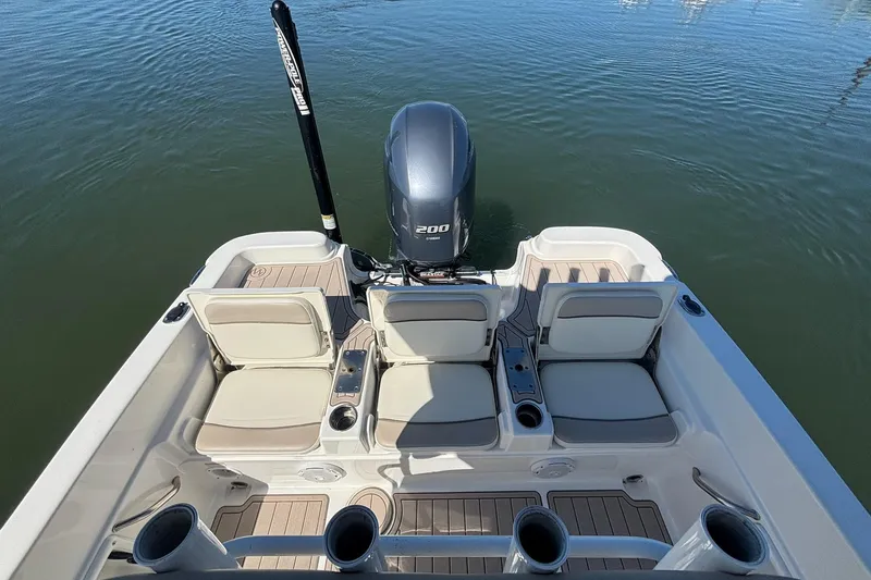 Slide: The Image of 2016 NauticStar 231 Coastal boat interior with seating and outboard motor. - 7