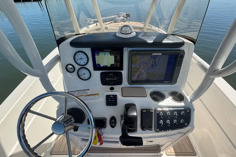 Slide: The Image of 2016 NauticStar 231 Coastal boat dashboard with navigation and control systems. - 9