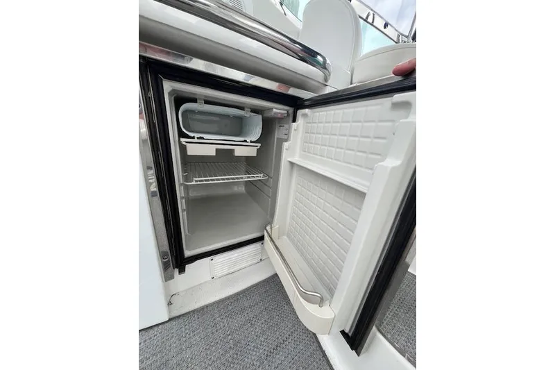 Slide: The Image of Open refrigerator on 2005 Formula 37 Performance Cruiser boat, showing interior shelves. - 10