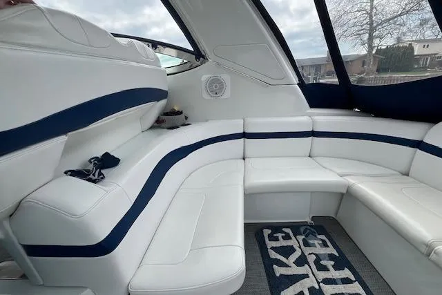 Slide: The Image of Interior of a 2005 Formula 37 Performance Cruiser with white seating and blue accents. - 13