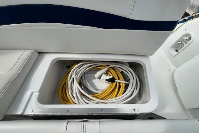 Slide: The Image of Storage compartment with coiled cables on a 2005 Formula 37 Performance Cruiser boat. - 14