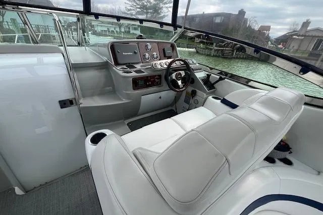 Slide: The Image of 2005 Formula 37 Performance Cruiser helm with white seating and modern controls. - 21