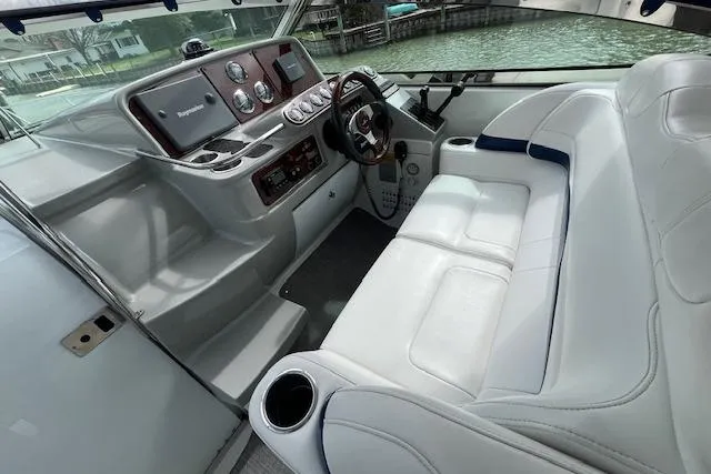 Slide: The Image of 2005 Formula 37 Performance Cruiser cockpit with white seating and modern dashboard controls. - 23