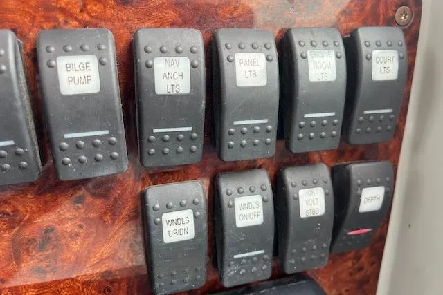 Slide: The Image of Control panel switches on a 2005 Formula 37 Performance Cruiser boat. - 32