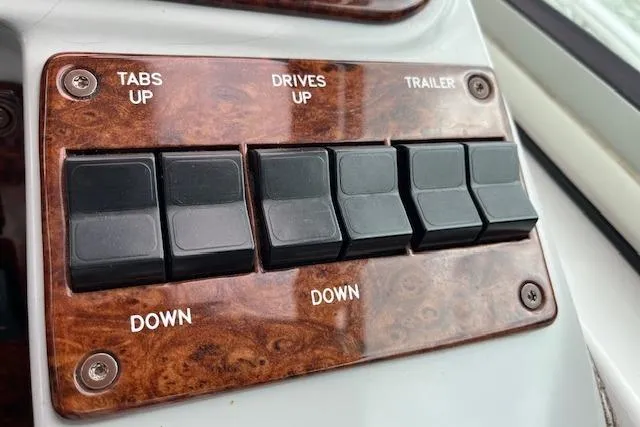 Slide: The Image of Control panel of a 2005 Formula 37 Performance Cruiser with switches for tabs, drives, and trailer. - 33