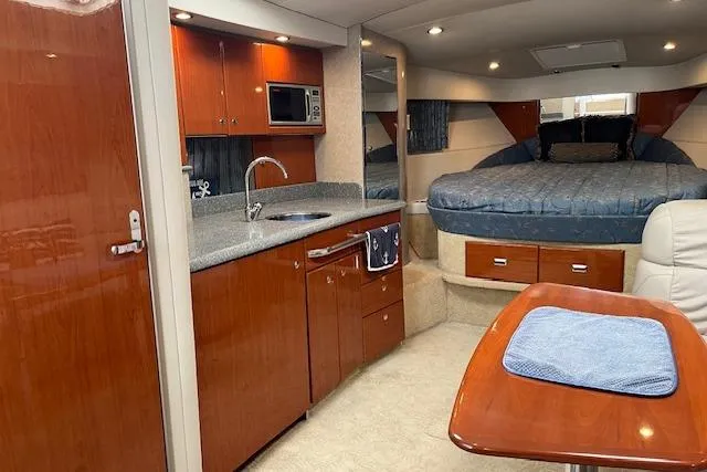 Slide: The Image of 2005 Formula 37 Performance Cruiser interior with kitchen, bed, and dining area. - 38
