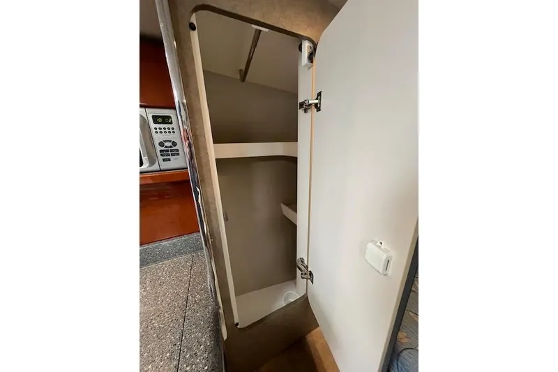 Slide: The Image of Open cabinet in 2005 Formula 37 Performance Cruiser kitchen area. - 48