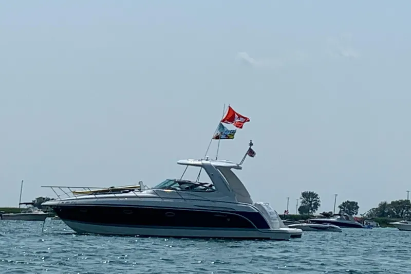 Slide: The Image of 2005 Formula 37 Performance Cruiser on water, flags flying, clear sky background. - 5