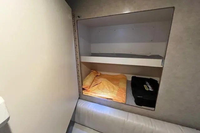Slide: The Image of Cabin storage in 2005 Formula 37 Performance Cruiser with bedding and equipment. - 52