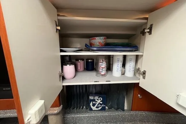 Slide: The Image of Cabinet interior with cups and dishes in a 2005 Formula 37 Performance Cruiser. - 58
