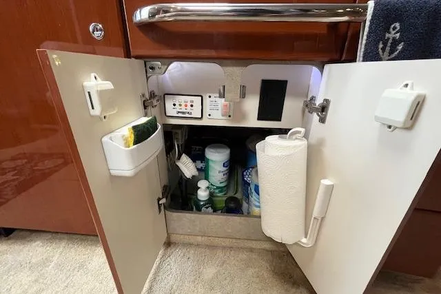 Slide: The Image of Open cabinet in 2005 Formula 37 Performance Cruiser with cleaning supplies and paper towel holder. - 62
