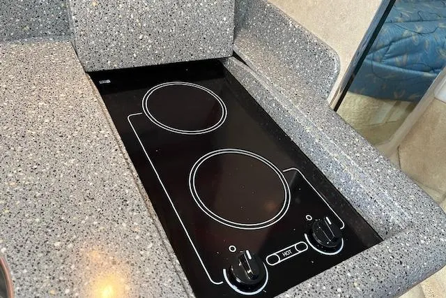 Slide: The Image of 2005 Formula 37 Performance Cruiser kitchen with sleek two-burner electric cooktop. - 63