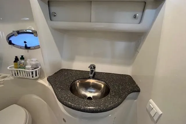 Slide: The Image of 2005 Formula 37 Performance Cruiser bathroom with sink and storage shelves. - 66
