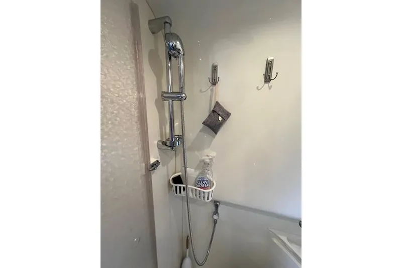 Slide: The Image of Shower area in 2005 Formula 37 Performance Cruiser with chrome fixtures and cleaning supplies. - 67