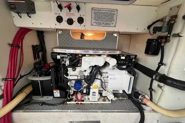 Slide: The Image of Engine room of a 2005 Formula 37 Performance Cruiser with visible generator and wiring. - 71
