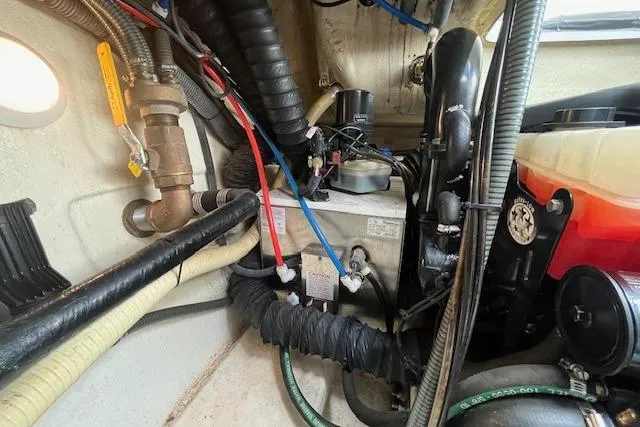 Slide: The Image of Engine compartment of a 2005 Formula 37 Performance Cruiser with visible hoses and components. - 74