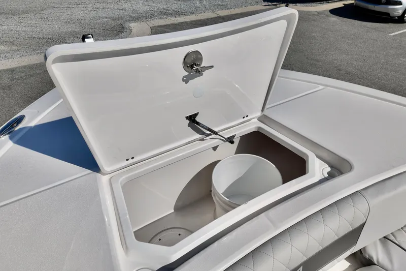 Slide: The Image of Open storage compartment on 2026 Sea Fox 282 Hybrid LT boat, featuring a white bucket inside. - 16