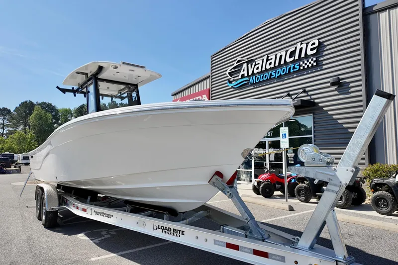 Slide: The Image of 2026 Sea Fox 282 Hybrid LT boat on trailer at Avalanche Motorsports dealership. - 2