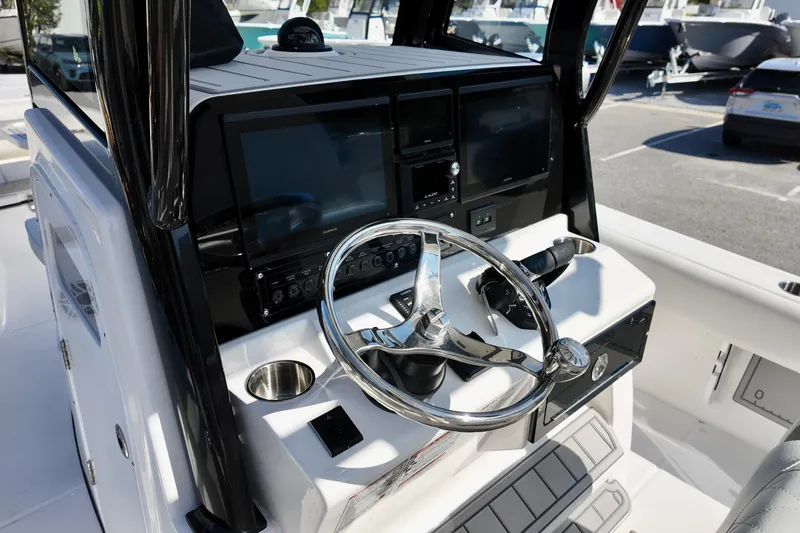 Slide: The Image of Helm of 2026 Sea Fox 282 Hybrid LT boat with modern controls and steering wheel. - 21