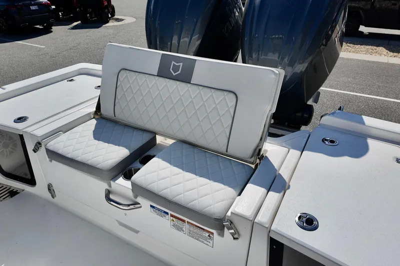 Slide: The Image of 2026 Sea Fox 282 Hybrid LT boat with cushioned seating and dual outboard motors. - 23