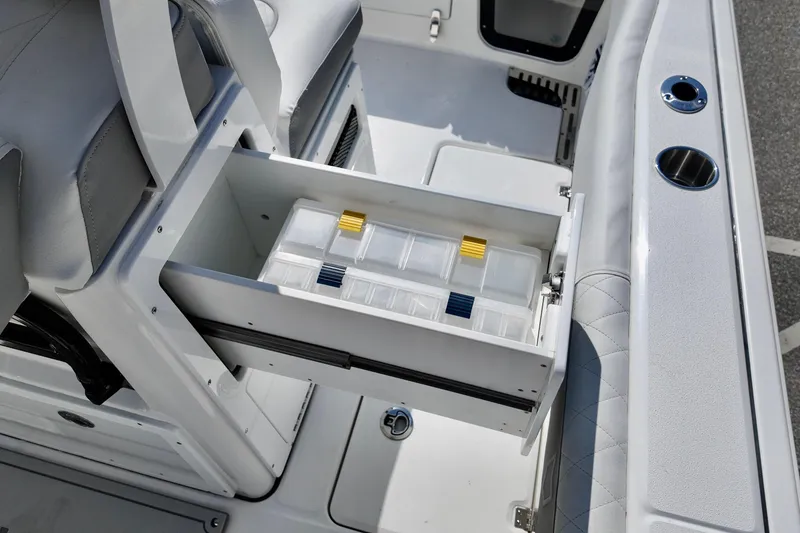 Slide: The Image of 2026 Sea Fox 282 Hybrid LT boat with open storage drawer and tackle boxes. - 26